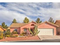 Charming single-story home with a desert landscape, barrel tile roof, and a two car garage at 7140 Pascal Dr, Las Vegas, NV 89156