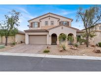 Charming two-story home featuring a well-manicured front yard with desert landscaping and a two car garage at 7878 Brianna Cheerful Ave, Las Vegas, NV 89178