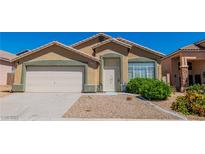 Charming single-story home featuring desert landscaping, a two-car garage, and a welcoming front entrance at 7990 Timber Horn Ct, Las Vegas, NV 89147