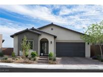 Charming single-story home with a modern design, desert landscaping, and an attached two-car garage at 11813 Pippa Ave, Las Vegas, NV 89138
