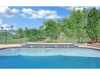 Relaxing pool featuring a view of the green golf course, landscaping, and blue sky at 1324 European Dr, Henderson, NV 89052