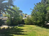 Charming yellow two-story home with mature trees and large front yard at 1385 Ringe Ln, Las Vegas, NV 89110