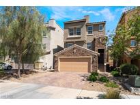 Charming two-story home with stone accents, a two-car garage, and landscaped front yard at 378 Gracious Way, Henderson, NV 89011