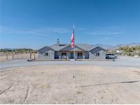 Charming single-story home with grey exterior, covered porch, and well-manicured gravel driveway at 3880 Rudek St, Pahrump, NV 89061
