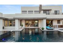 Stunning backyard pool area with modern lounge furniture, perfect for relaxation and entertainment at 4024 Desert Trace Ct, Las Vegas, NV 89129