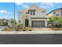Two story home with modern design, desert landscaping and a gray garage door at 513 Monarch Ridge Ct, North Las Vegas, NV 89084