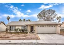 Charming single-story home featuring a two-car garage and a welcoming front porch at 5809 Robin Ln, Las Vegas, NV 89108