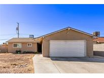 Single story home with a two-car garage and low maintenance xeriscape front yard at 5813 Halifax Ave, Las Vegas, NV 89107