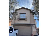 Charming two-story home featuring a balcony and an attached two-car garage at 7011 Azure Beach St, Las Vegas, NV 89148