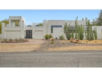Contemporary home featuring desert landscaping, a private balcony, and an attached two-car garage at 8525 W Verde Way, Las Vegas, NV 89149