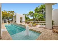 Inviting pool area with a cabana and water features, perfect for relaxation and entertainment at 8525 W Verde Way, Las Vegas, NV 89149