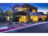 Contemporary home showcasing modern architecture and a well-manicured front yard at dusk at 917 Vegas View Dr, Henderson, NV 89052