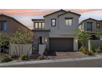 Charming two-story home boasts a neutral color scheme, a well-maintained front yard, and a two-car garage at 12053 Arrebol Ave, Las Vegas, NV 89138