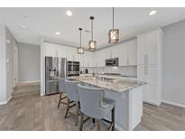 Beautiful kitchen with stainless steel appliances, granite countertops, and pendant lighting at 169 Volti Subito Way, Henderson, NV 89011