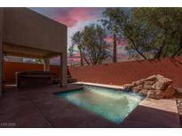 Inviting pool with integrated spa and rock waterfall feature at 214 Bella Matese Ave, Las Vegas, NV 89183