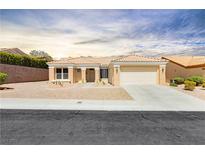 Charming single-story home featuring a two-car garage, desert landscaping, and a tile roof at 2205 Beacon Ridge Dr, Las Vegas, NV 89134