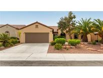 Charming single-story home with desert landscaping, a tile roof and a two-car garage at 2357 Aztec Ruin Way, Henderson, NV 89044