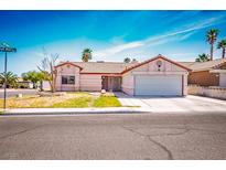 Charming single-story home featuring a well-maintained front yard and a two-car garage at 3016 Light Wind Ct, Las Vegas, NV 89108