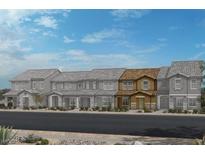 New townhomes are featured with neutral exteriors, complemented by desert landscaping and clear blue skies at 3632 Stoppani Ave, Henderson, NV 89044