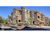 Multi-story building showing detailed architecture, with dual toned stucco and manicured landscaping with secure front fence at 3975 N Hualapai Way # 147, Las Vegas, NV 89129