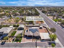 Stunning aerial view of a single-Gathering home showcasing its solar panels, three car garage and generous lot at 4818 Al Carrison St, Las Vegas, NV 89149