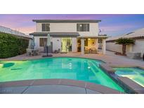 Inviting backyard showcases a refreshing pool and spa, complemented by a covered patio area perfect for entertaining at 781 Wigan Pier Dr, Henderson, NV 89002