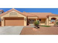 Charming single-story home showcasing a desert landscape, a terracotta roof, and double-door entrance at 9912 Woodhouse Dr, Las Vegas, NV 89134