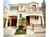 Inviting two-story home featuring a charming balcony, a two-car garage, and desert landscaping at 10372 Beautiful Fruit St, Las Vegas, NV 89183
