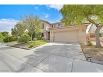 Charming two-story home features a well-manicured lawn, mature trees, and an attached two-car garage at 10409 Snowdon Flat Ct, Las Vegas, NV 89129