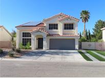 Charming two-story home features desert landscaping, a red tile roof, and solar panels at 1508 Silver Knoll Ave, Las Vegas, NV 89123