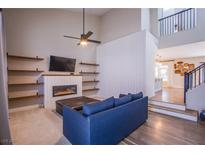 Bright living room with fireplace, built-in shelving, and a comfortable blue sofa at 1508 Silver Knoll Ave, Las Vegas, NV 89123