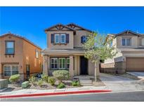 Charming two-story home featuring a well-manicured front yard and covered entry at 165 Calm Morning Ave, Henderson, NV 89002