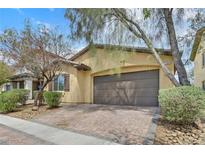 Charming single-story home with a two-car garage and a well-manicured front yard at 2104 Leatherbridge Ct, North Las Vegas, NV 89081