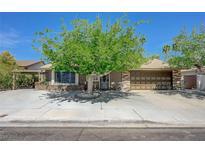 Charming single-story home with mature trees and a welcoming front yard, plus a covered carport and two-car garage at 3266 Mountain Spring Rd, Las Vegas, NV 89146