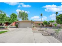 Charming single-story home with a well-maintained front yard, desert landscaping, and a two-car garage at 6408 Shawnee Pl, Las Vegas, NV 89107