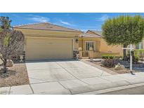 Charming single-story home with a well-manicured lawn and a two-car garage at 7720 Fruit Dove St, North Las Vegas, NV 89084