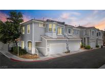 Charming townhome exterior with two-car garage and well-maintained landscaping at 224 Devotion Ct, Henderson, NV 89052