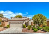 Charming single-story home featuring a well-manicured front yard and a two-car garage at 2539 Stardust Valley Dr, Henderson, NV 89044