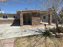 Cozy single-story home featuring stone accents, a covered parking area, and a low-maintenance front yard at 3700 Hickey Ave, North Las Vegas, NV 89030