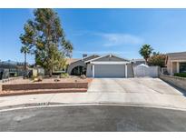 Charming single-story home featuring desert landscaping, a two-car garage, and a welcoming entryway at 386 Summer Creek Ct, Henderson, NV 89002