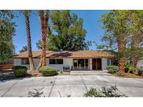 Charming single-story home with lush greenery and a well-maintained front yard at 4012 Vegas Dr, Las Vegas, NV 89108