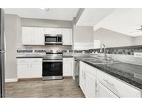 Modern kitchen featuring white cabinets, stainless steel appliances, and granite countertops at 45 Maleena Mesa St # 1424, Henderson, NV 89074