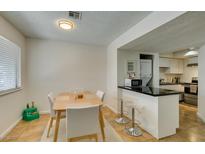 Charming dining area adjacent to the kitchen, featuring a modern table with seating for four at 5725 Smoke Ranch Rd # A, Las Vegas, NV 89108
