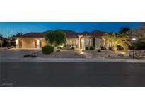 Charming single-story home features a three car garage and a meticulously landscaped front yard with desert landscaping at 5858 Majestic Tide Ave, Las Vegas, NV 89131