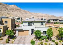 Stunning two-story home featuring desert landscaping and a mountain backdrop at 6433 Farness St, Las Vegas, NV 89135