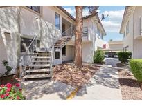 Charming condo exterior with landscaped grounds and stairway access to upper units at 6711 W Charleston Blvd # 4, Las Vegas, NV 89146