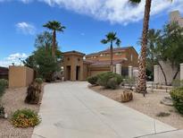 Elegant home featuring a long driveway, desert landscaping, and a charming stucco exterior at 1091 Casa Palermo Cir, Henderson, NV 89011