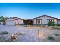 Charming single-story home featuring a desert landscape, attached garage and paved walkway to covered front entry at 197 Ebb Tide Cir, Las Vegas, NV 89123