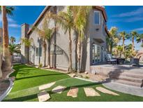 Inviting backyard with lush turf, stone accents, and cozy patio seating for outdoor relaxation and entertaining at 3924 Diamond Ridge St, Las Vegas, NV 89129