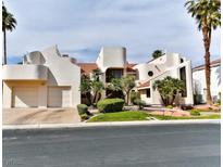Stunning contemporary home featuring a unique design, mature landscaping, and a three-car garage at 42 Gulf Stream Ct, Las Vegas, NV 89113